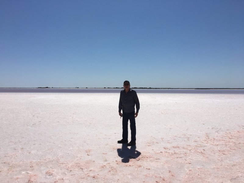 a man standing next to a body of water