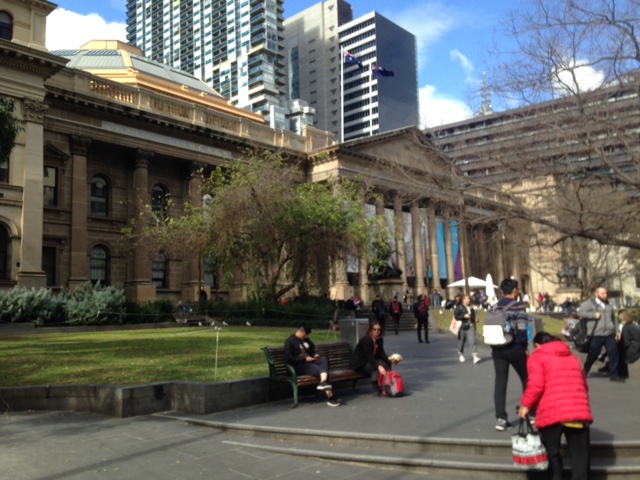 a group of people walking on a city street