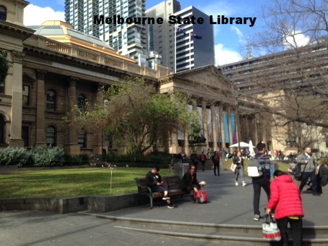 a group of people walking down a street next to a building
