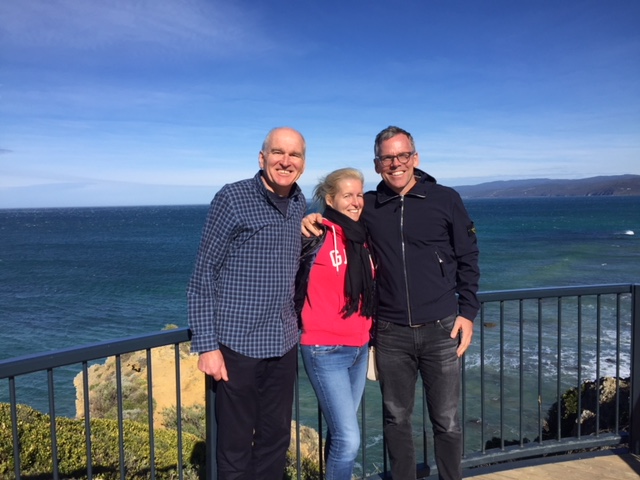 a man standing next to a body of water